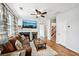 Comfortable living room featuring a fireplace, ceiling fan, and staircase access at 505 Rendezvous Rd, Acworth, GA 30102