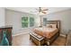 Main bedroom with natural light, ceiling fan, and a rustic wood bed frame at 505 Rendezvous Rd, Acworth, GA 30102