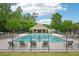 Community pool surrounded by lounge chairs and a fence, with a building in the background at 505 Rendezvous Rd, Acworth, GA 30102