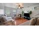 Cozy living room with fireplace, hardwood floors, and ample seating for relaxation at 70 Fairclift Dr, Covington, GA 30016