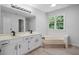Bright bathroom with double sinks, soaking tub, large mirror, and natural light from a window at 1368 Christiana Dr, Lawrenceville, GA 30043