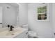 Bathroom featuring white fixtures and a window allowing natural light at 1368 Christiana Dr, Lawrenceville, GA 30043