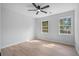 Well-lit bedroom featuring two windows, light wood floors, and neutral walls at 1368 Christiana Dr, Lawrenceville, GA 30043