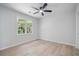 Bright bedroom featuring light wood floors, a large window, and neutral walls at 1368 Christiana Dr, Lawrenceville, GA 30043