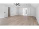 Spacious bedroom with light wood floors, bright white walls, and a modern ceiling fan at 1368 Christiana Dr, Lawrenceville, GA 30043