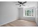 Well-lit bedroom featuring a large window, closet, light wood floors, and neutral walls at 1368 Christiana Dr, Lawrenceville, GA 30043