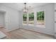 Dining area illuminated by modern lighting fixtures, with windows bringing the outdoors in at 1368 Christiana Dr, Lawrenceville, GA 30043