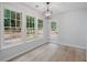Dining area illuminated by modern lighting fixtures and exterior door at 1368 Christiana Dr, Lawrenceville, GA 30043