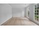 Bright empty room featuring light colored wood flooring and large windows at 1368 Christiana Dr, Lawrenceville, GA 30043