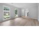 Bright empty room featuring light colored wood flooring and large windows at 1368 Christiana Dr, Lawrenceville, GA 30043