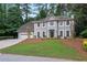 Charming two-story home with a manicured lawn and a two-car garage at 1368 Christiana Dr, Lawrenceville, GA 30043