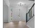 Bright foyer featuring a modern light fixture and light-colored wood flooring at 1368 Christiana Dr, Lawrenceville, GA 30043