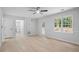 Bright living room with wood flooring, ceiling fan, and a view of the outdoors from windows at 1368 Christiana Dr, Lawrenceville, GA 30043