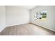Sunlit bedroom with wood floors and a view from the window at 1471 Stephens View Dr, Loganville, GA 30052