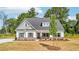 Charming single-story home features a welcoming front porch, green shutters, and landscaped yard at 1471 Stephens View Dr, Loganville, GA 30052