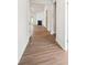 Hallway with wood floors leading to the fireplace in the living area at 1471 Stephens View Dr, Loganville, GA 30052