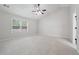 Spacious, carpeted bedroom with ceiling fan, large window and neutral colors at 1736 Dylan Pl, Lawrenceville, GA 30043