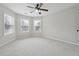 This carpeted bedroom is bright with three windows and offers a ceiling fan at 1736 Dylan Pl, Lawrenceville, GA 30043