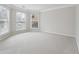 Spacious bedroom with neutral walls and carpeting and abundant natural light from bay windows at 1736 Dylan Pl, Lawrenceville, GA 30043