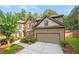 Charming two-story home featuring brick and tan siding, with a well-manicured lawn and two car garage at 1736 Dylan Pl, Lawrenceville, GA 30043