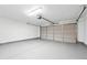 Spacious garage with epoxy floors and a white door at 1736 Dylan Pl, Lawrenceville, GA 30043