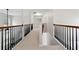 Upstairs hallway with wood and iron balusters, leading to bedrooms at 1736 Dylan Pl, Lawrenceville, GA 30043