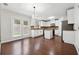 Bright kitchen featuring white cabinets, stainless steel appliances, hardwood flooring, and backyard access at 1736 Dylan Pl, Lawrenceville, GA 30043