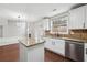 Bright kitchen with granite counters, stainless steel appliances and open view to living area at 1736 Dylan Pl, Lawrenceville, GA 30043