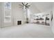 Open-concept living room with fireplace, soaring ceilings, and large windows leading into an eat-in kitchen at 1736 Dylan Pl, Lawrenceville, GA 30043