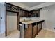 A basement wet bar area featuring a dark wood cabinets, granite countertop, and a wine rack at 340 Kincardine Way, Alpharetta, GA 30022