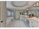 Bright bathroom with a soaking tub, glass shower, double sinks, and ample counter space at 340 Kincardine Way, Alpharetta, GA 30022