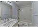 Cozy bathroom featuring a single sink vanity, shower-tub combo, and bright, white tiles at 340 Kincardine Way, Alpharetta, GA 30022