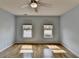 Serene bedroom with hardwood floors, light blue walls and natural light from two windows at 340 Kincardine Way, Alpharetta, GA 30022
