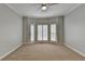 Spacious bedroom with neutral carpet, gray walls, ceiling fan, and bright natural light at 340 Kincardine Way, Alpharetta, GA 30022
