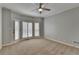 Cozy bedroom with plush carpet, neutral walls, and access to the outdoor patio area at 340 Kincardine Way, Alpharetta, GA 30022