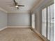 Neutral bedroom with plush carpet, ample light from shuttered windows, and ceiling fan at 340 Kincardine Way, Alpharetta, GA 30022