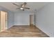 Bedroom features hardwood floors, light blue walls, and an open doorway at 340 Kincardine Way, Alpharetta, GA 30022