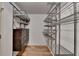 Walk-in closet with custom shelving and storage drawers for organized living at 340 Kincardine Way, Alpharetta, GA 30022