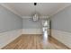 Dining room features hardwood flooring, modern light fixture and wainscoting at 340 Kincardine Way, Alpharetta, GA 30022
