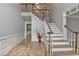 Bright foyer features hardwood floors, a staircase, and decorative trim throughout at 340 Kincardine Way, Alpharetta, GA 30022