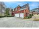 Brick home featuring a two-car garage and a spacious driveway at 340 Kincardine Way, Alpharetta, GA 30022