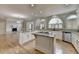 Open kitchen with granite countertops, white cabinets, hardwood floors, and stainless steel appliances at 340 Kincardine Way, Alpharetta, GA 30022