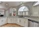Stylish kitchen featuring granite countertops, stainless steel appliances, and arched windows for natural light at 340 Kincardine Way, Alpharetta, GA 30022