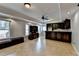Basement living room with tile flooring, built-in bar area and natural light at 340 Kincardine Way, Alpharetta, GA 30022