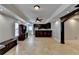 Finished basement with tile flooring, built-in bar, and dark wood finishes at 340 Kincardine Way, Alpharetta, GA 30022