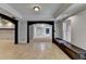 Open living room with arched doorway, tile flooring, and window seat with bench at 340 Kincardine Way, Alpharetta, GA 30022