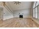 Light-filled living room showcasing high ceilings, hardwood floors, fireplace, and staircase at 340 Kincardine Way, Alpharetta, GA 30022