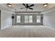 Spacious living room with large windows, plush carpeting, and neutral color palette at 340 Kincardine Way, Alpharetta, GA 30022