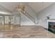 Bright and airy living room with hardwood floors, fireplace, and staircase at 340 Kincardine Way, Alpharetta, GA 30022