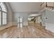 Spacious living room featuring hardwood floors, wainscoting, and an open floor plan to kitchen at 340 Kincardine Way, Alpharetta, GA 30022
